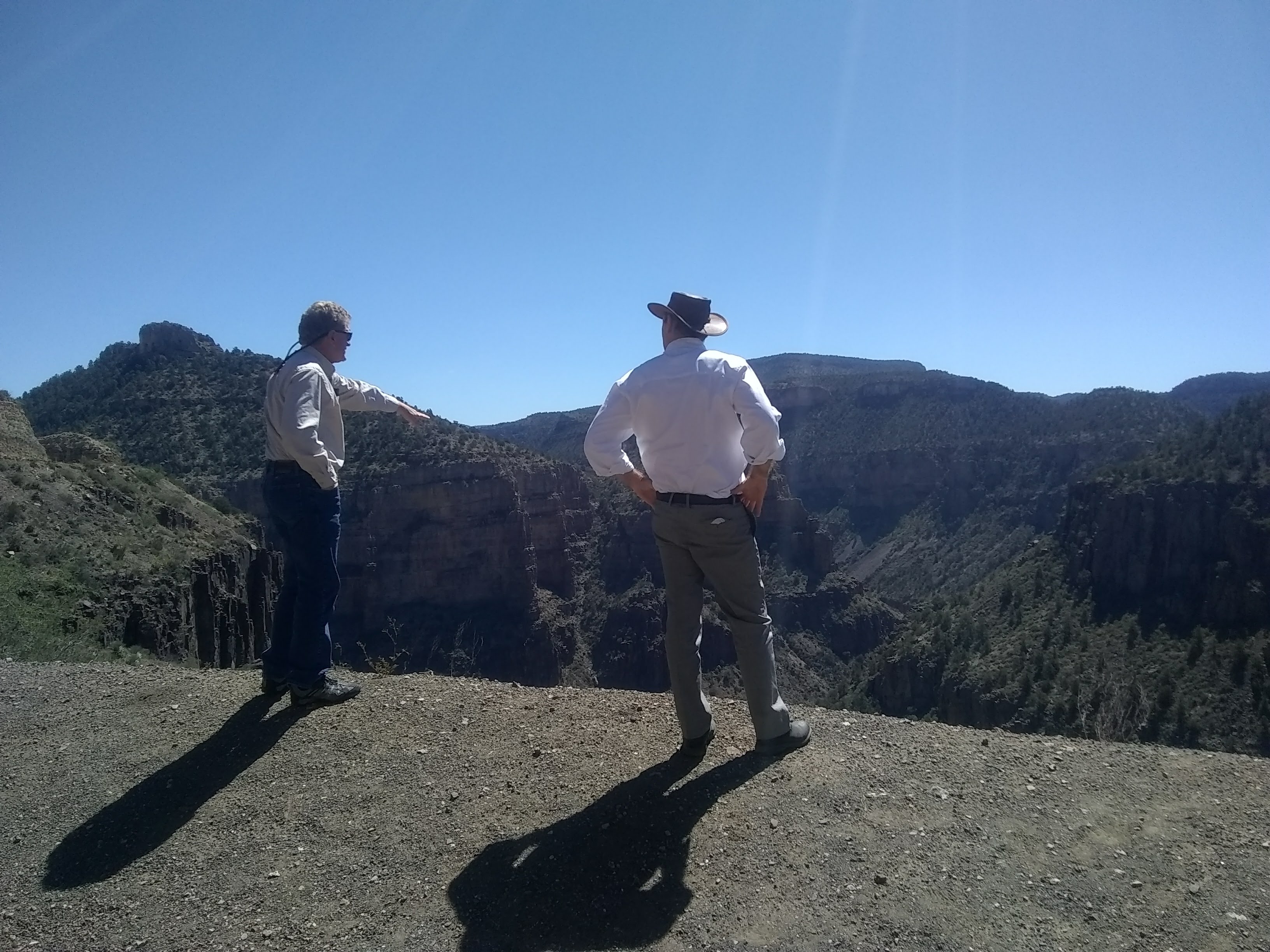 Associate Director of Tribal Extension Trent Teegerstrom (left) and Shane Burgess look out over the Salt River Canyon on an overlook north of Globe during their recent tour of Tribal Extension Offices.