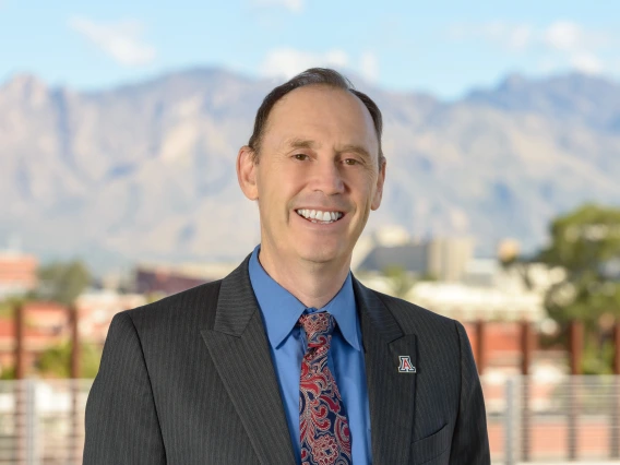Headshot of Shane C. Burgess with mountains in backdrop