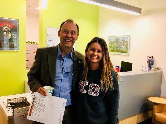 Vice President Burgess greets a student while visiting the advising offices at the Norton School for Family and Consumer Sciences.