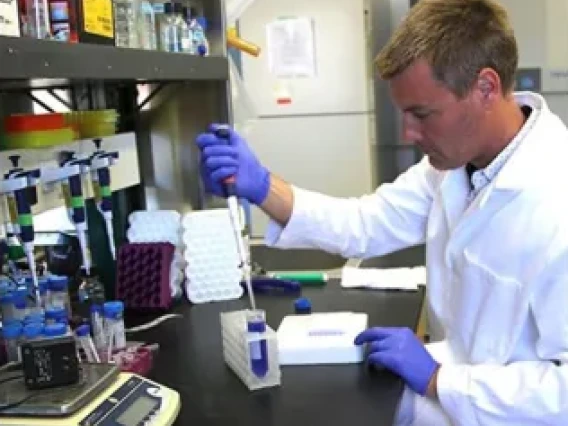 Scientist in lab with pipette in hand