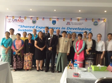 Group of men and women celebrating opening of international workshop at Yangon University.